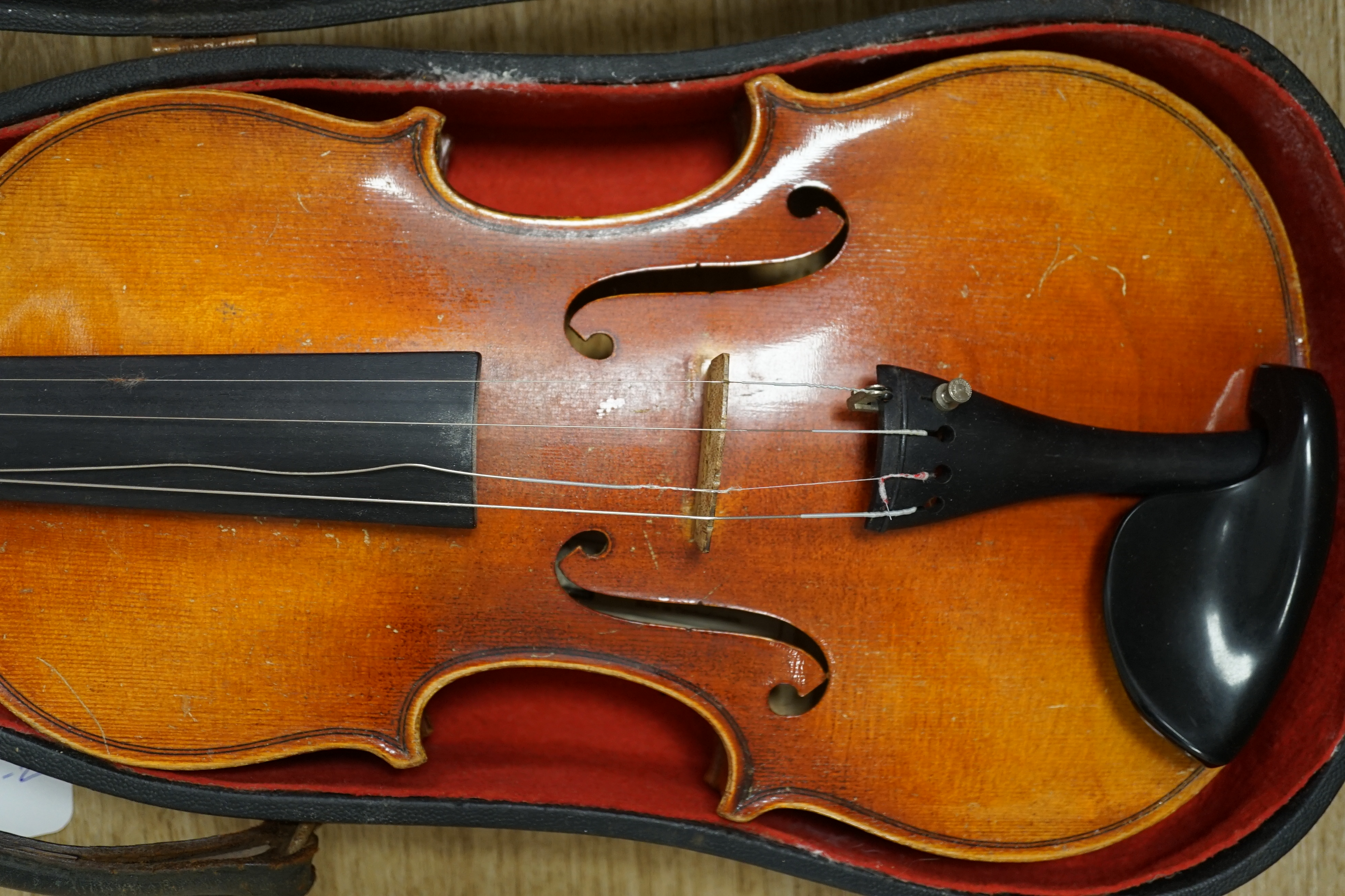 A cased Czechoslovakian student’s violin with Stradivarius label, length of body, 35.5cm, with spare strings